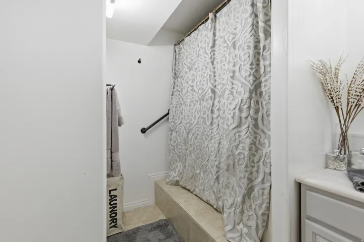 Full bathroom with a shower with shower curtain
