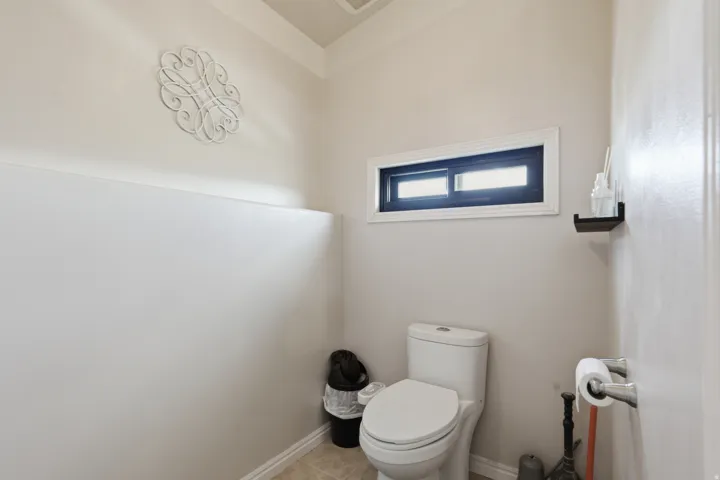 Bathroom with toilet and baseboards