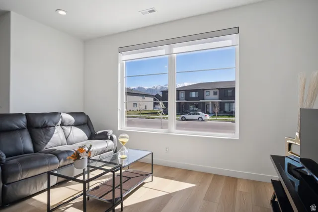 Living room featuring light wood-type flooring and recessed lighting