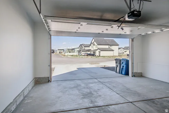Garage featuring a residential view and a garage door opener