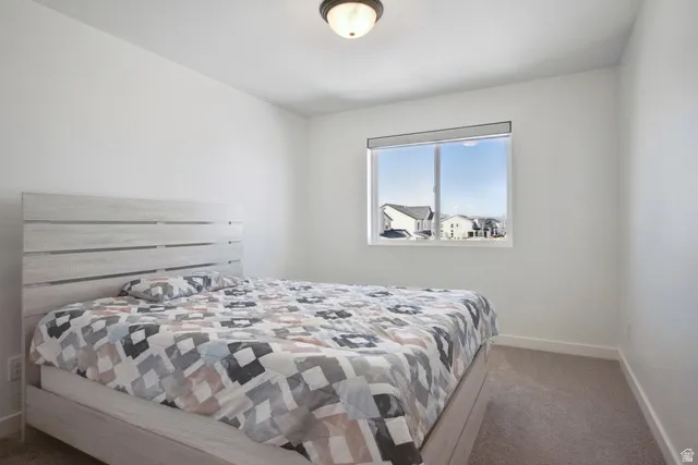 Bedroom featuring dark carpet