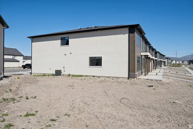 View of side of property with a cooling unit