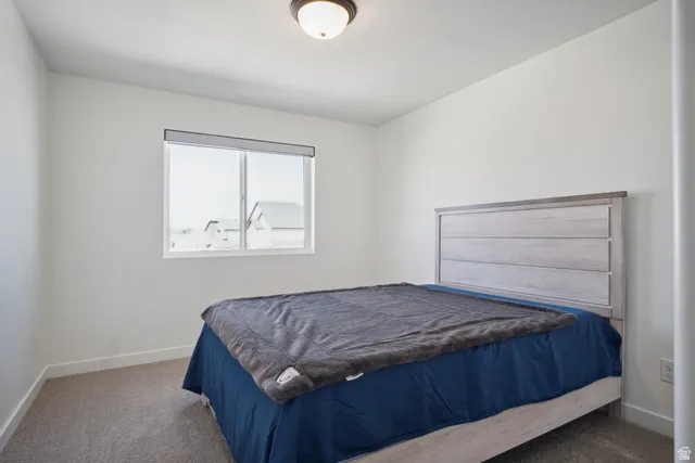 Bedroom with dark carpet