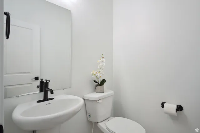 Half bath with toilet and a sink