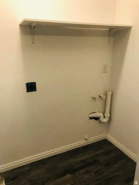 Laundry room with dark wood-type flooring, gas dryer hookup, and hookup for a washing machine