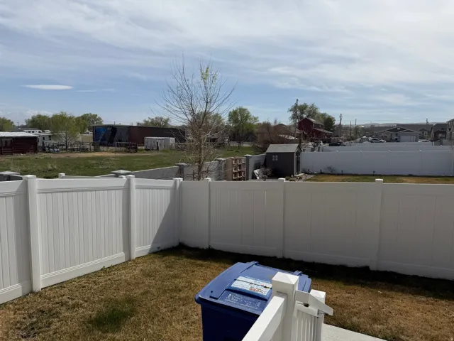 Fenced backyard featuring a shed