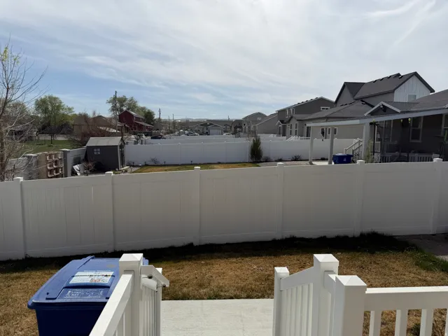 Fenced backyard with a residential view and a patio area