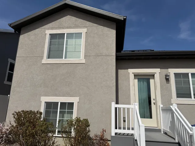 View of exterior entry featuring stucco siding