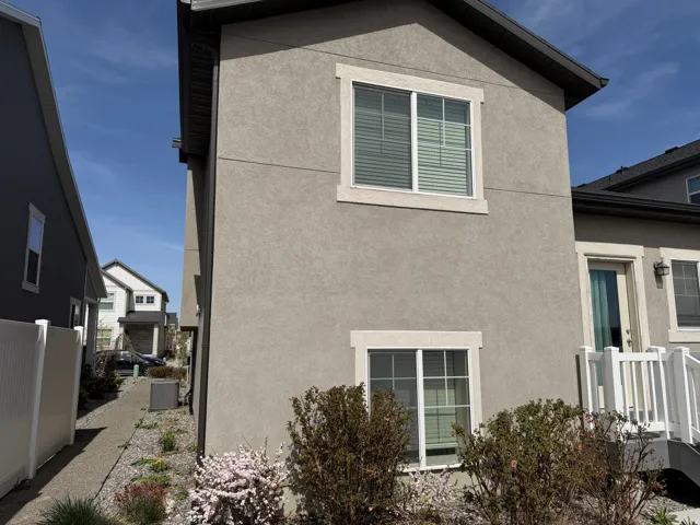 View of side of property featuring stucco siding