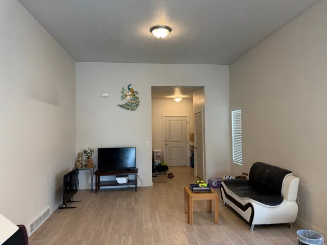Living area with light wood-style floors and baseboards