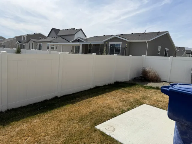 Fenced backyard featuring a residential view and a patio