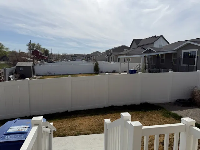 Fenced backyard featuring a residential view
