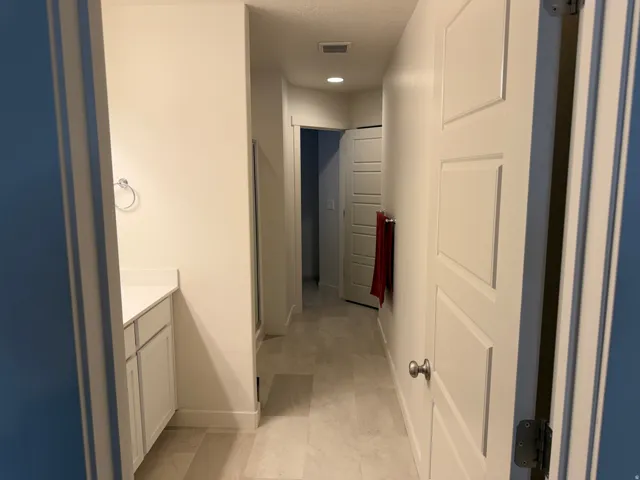 Bathroom featuring vanity, a stall shower, and recessed lighting