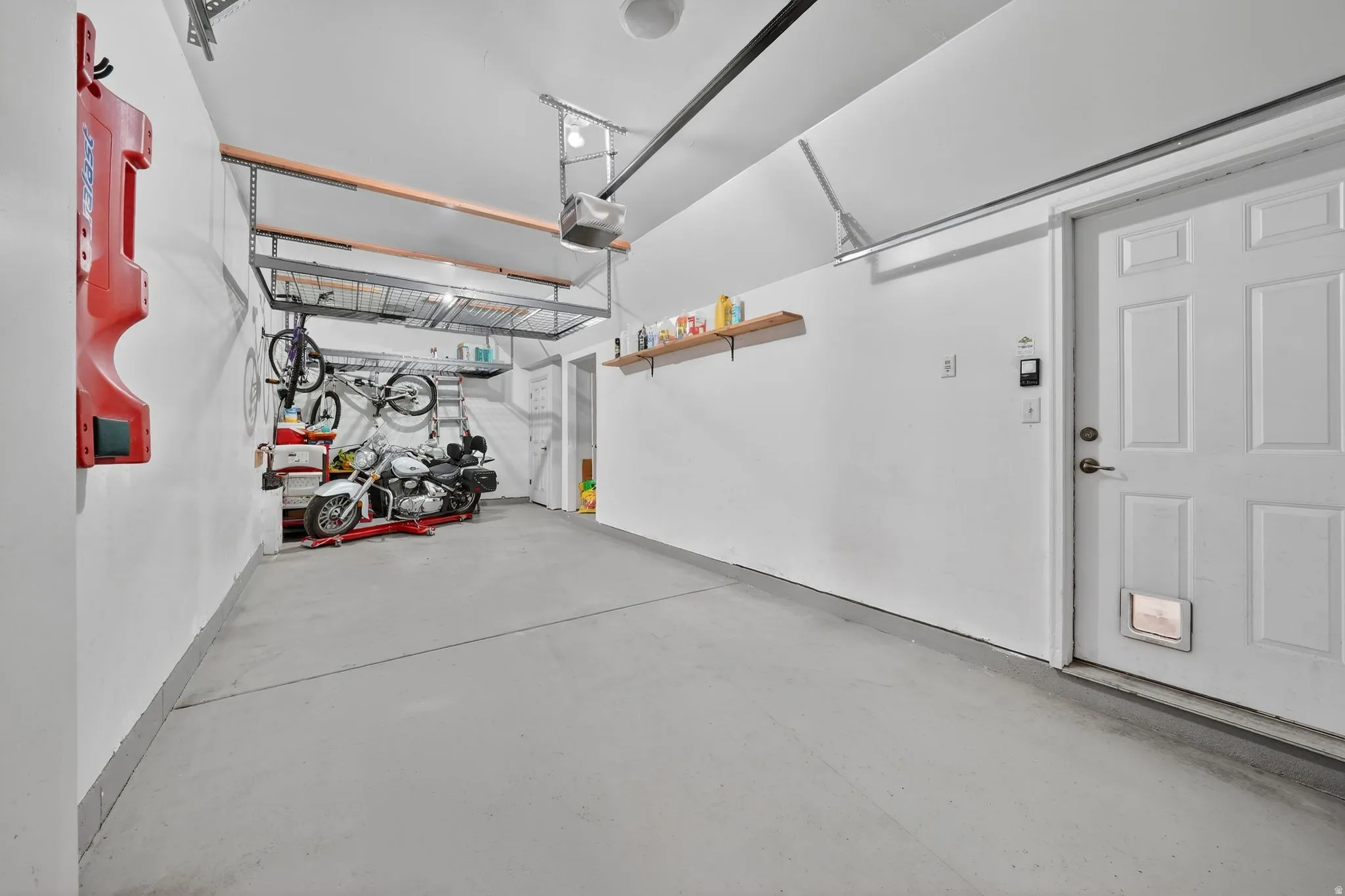 Garage featuring a garage door opener