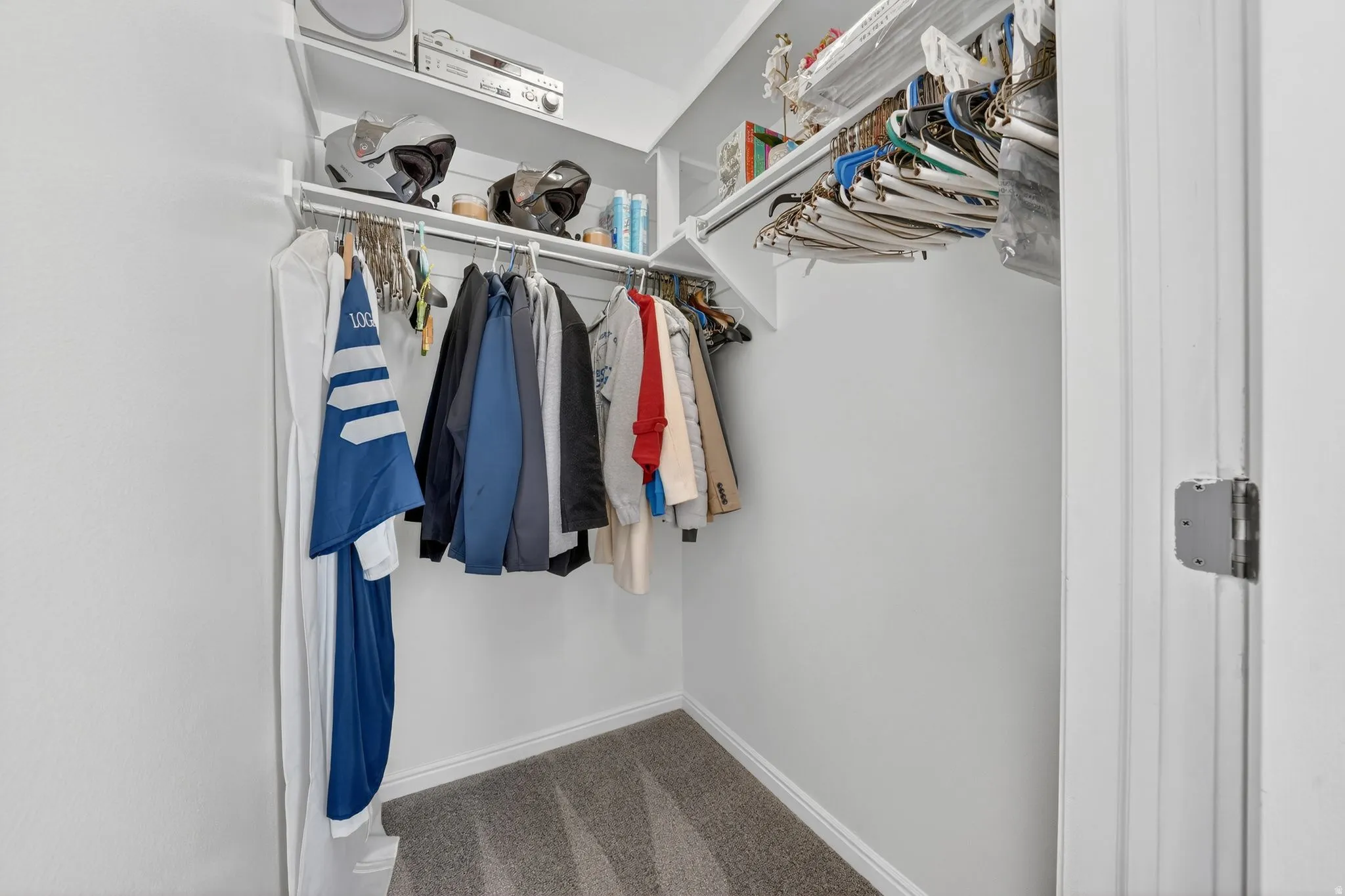 Walk in closet with light colored carpet