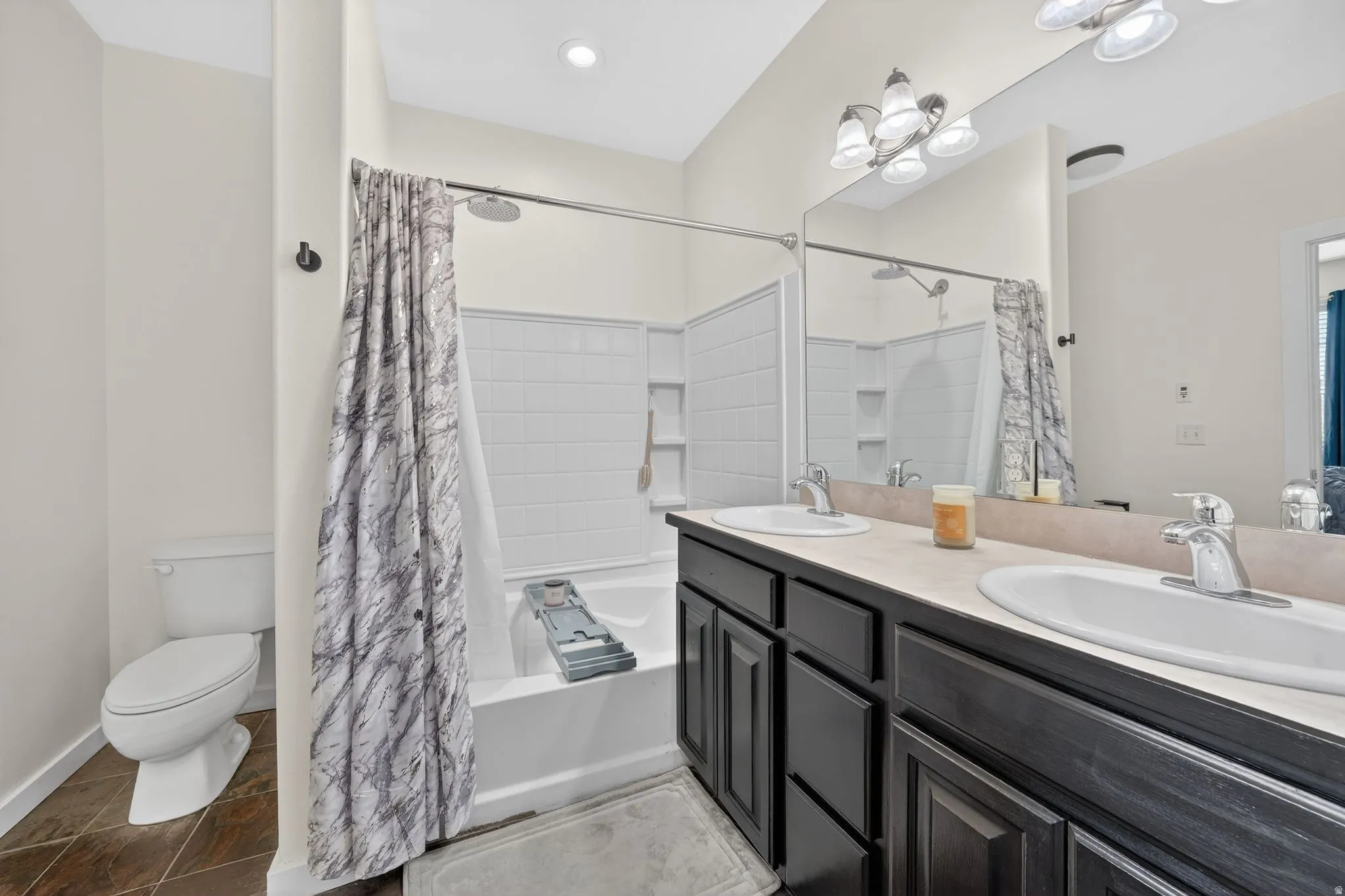 Bathroom with double vanity and shower / bath combo
