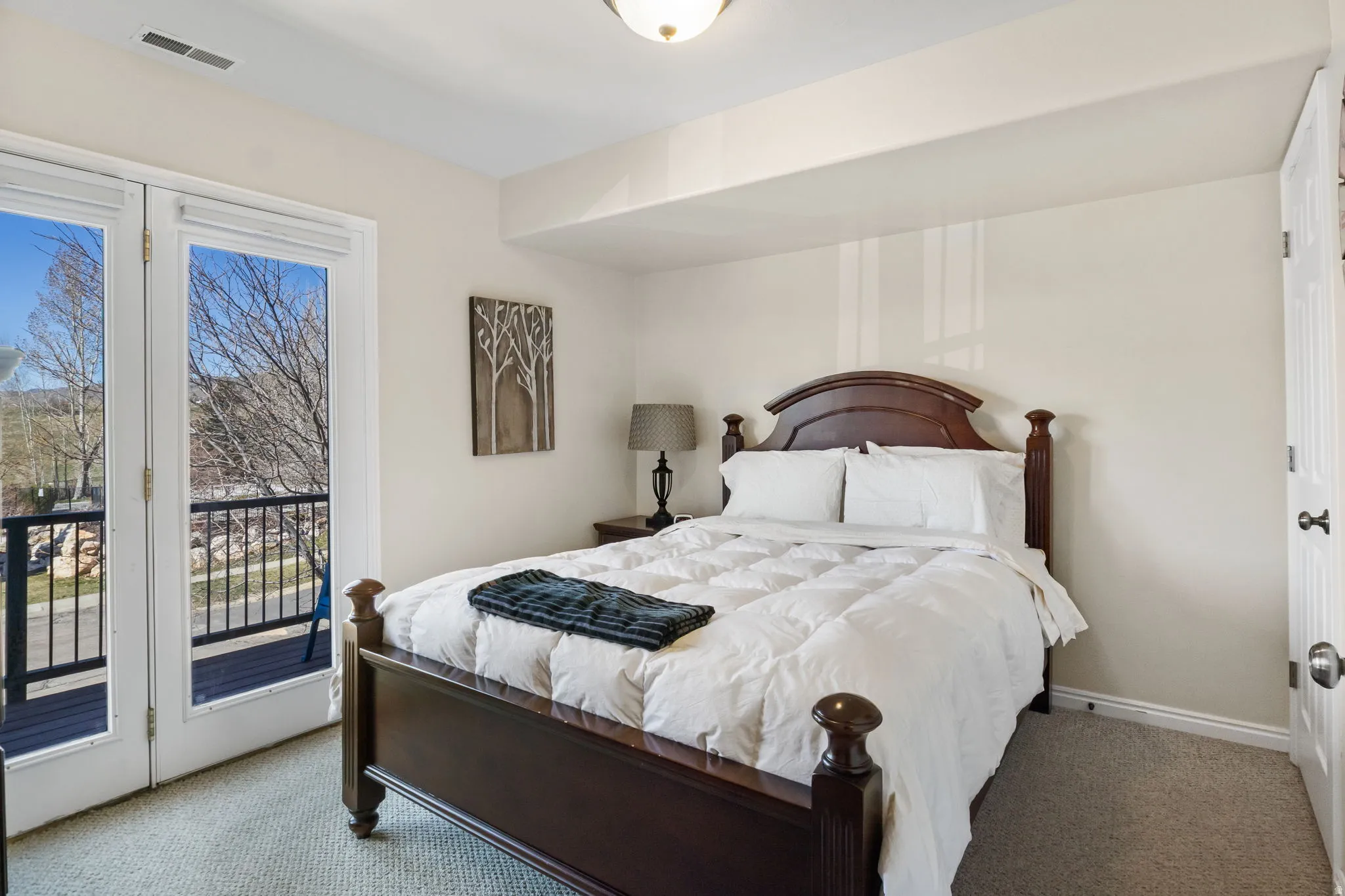 Carpeted bedroom with access to exterior