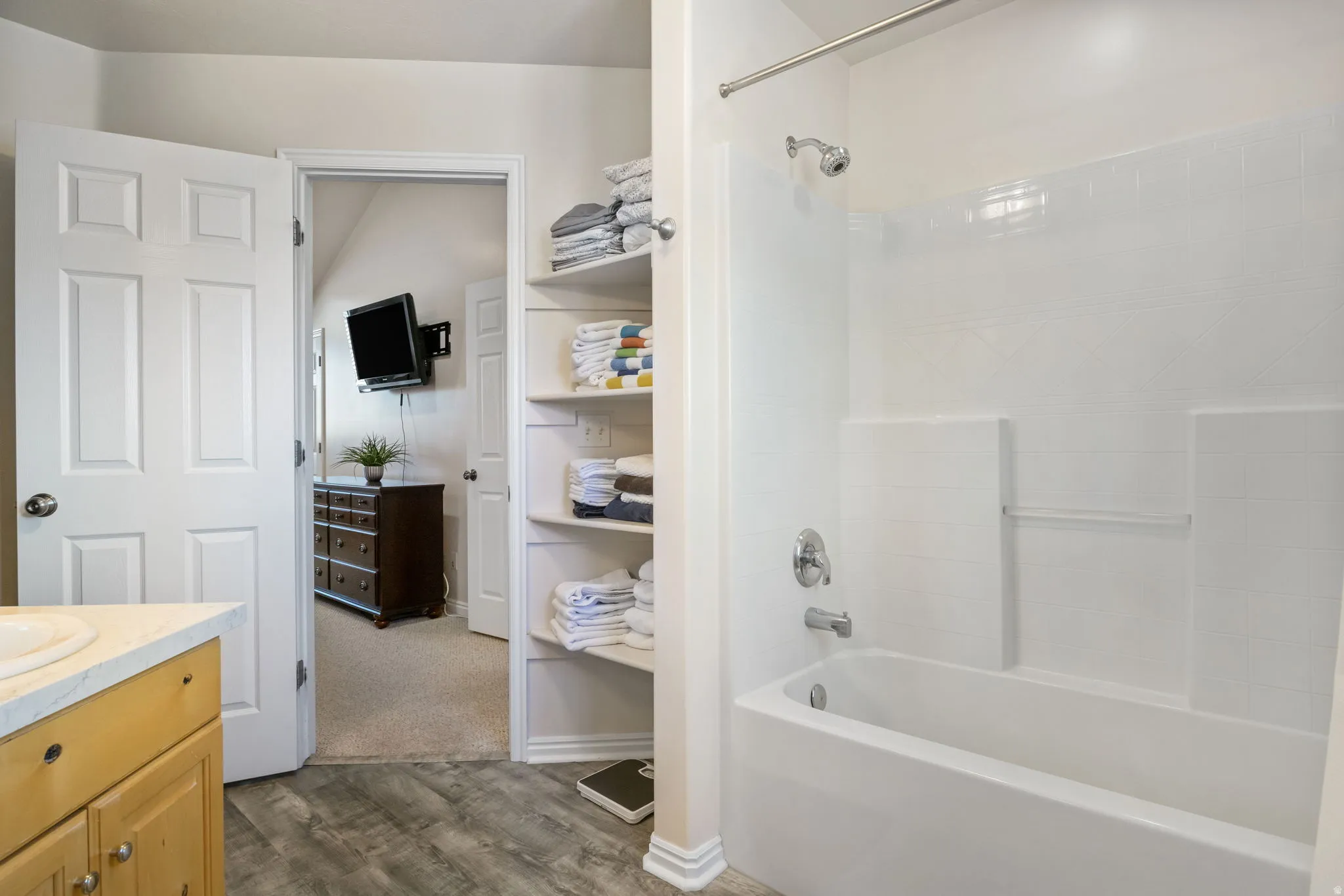 Full bath featuring vanity, dark wood finished floors, and shower / tub combination