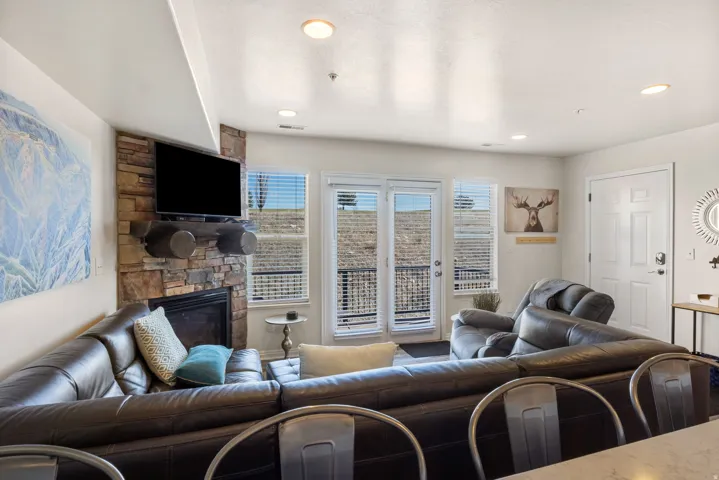 Living room featuring a stone fireplace