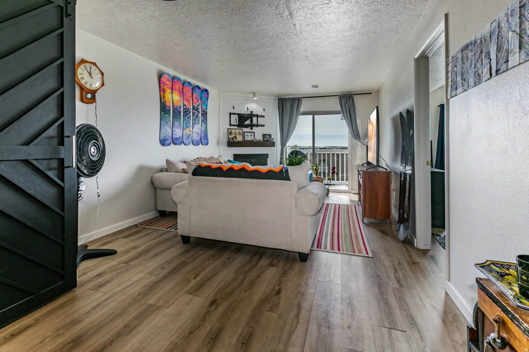 Living area with wood finished floors and a textured ceiling