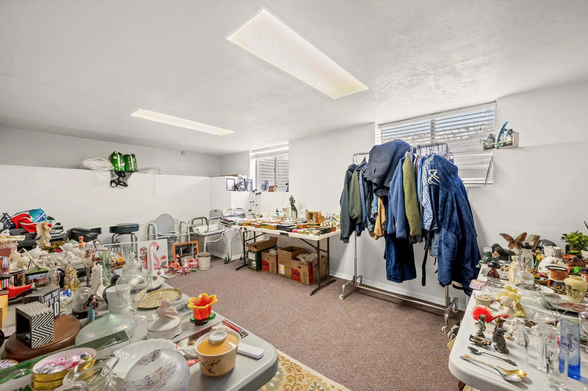 Miscellaneous room featuring light carpet and baseboards