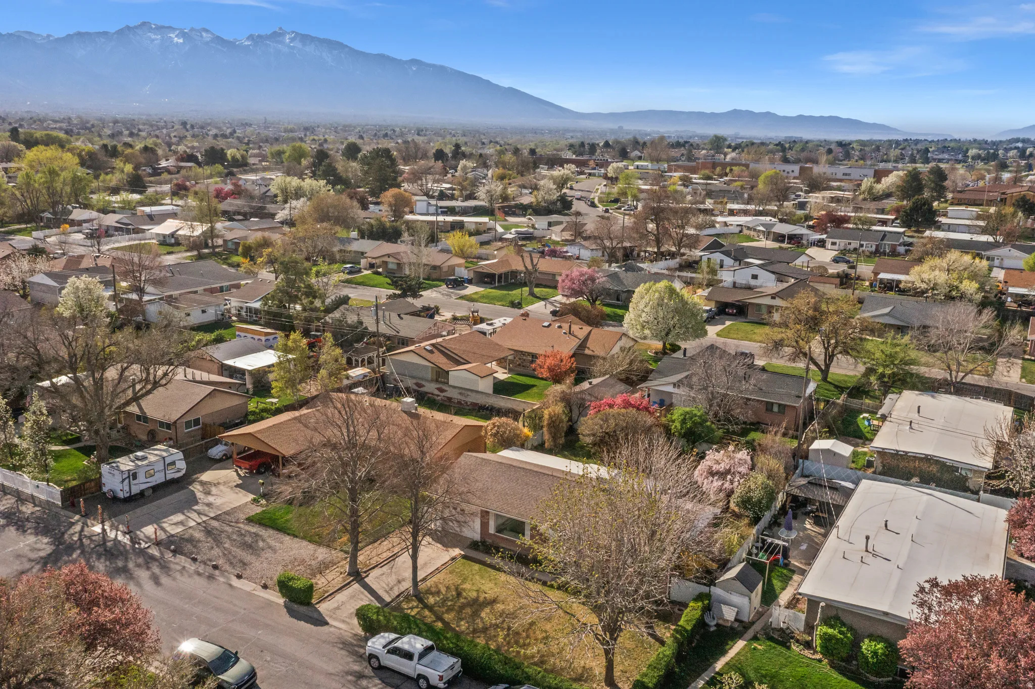 Aerial perspective of suburban area featuring a mountain backdrop