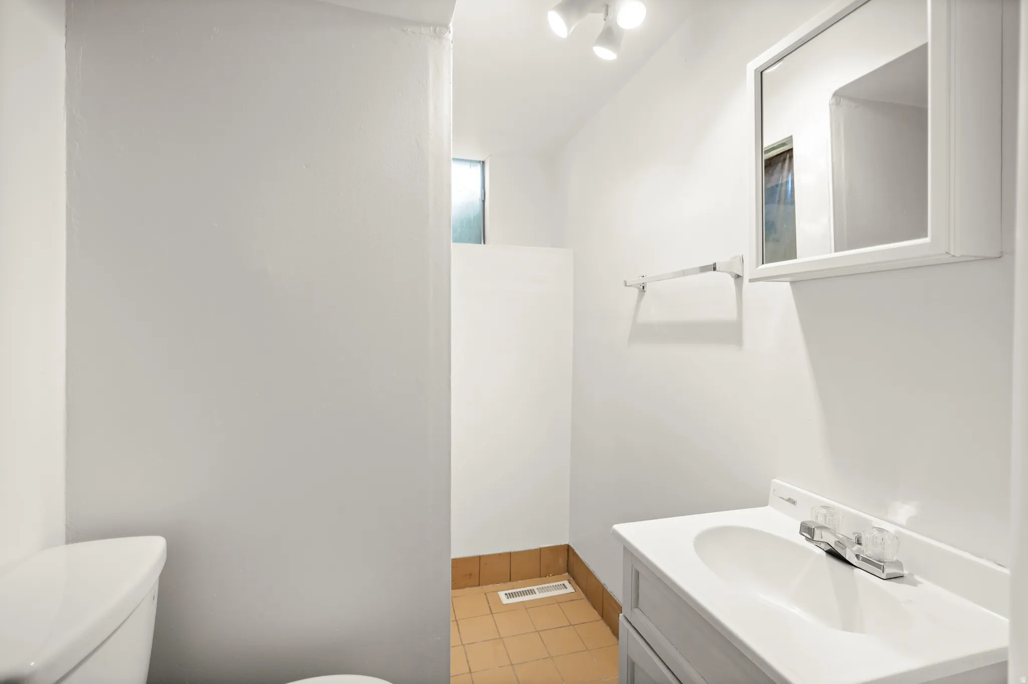 Bathroom featuring vanity and light tile patterned flooring
