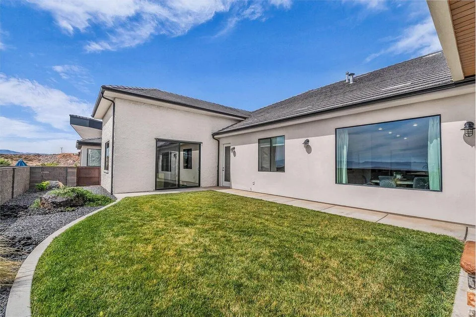 Back of property featuring stucco siding and a patio area