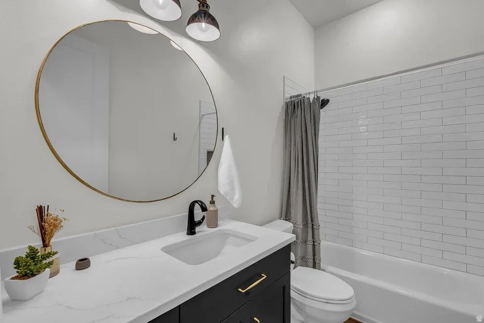 Full bathroom with vanity and shower / tub combo with curtain