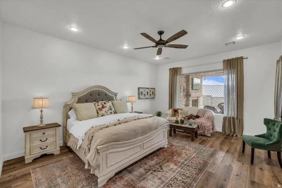 Bedroom featuring wood finished floors, ceiling fan, and recessed lighting