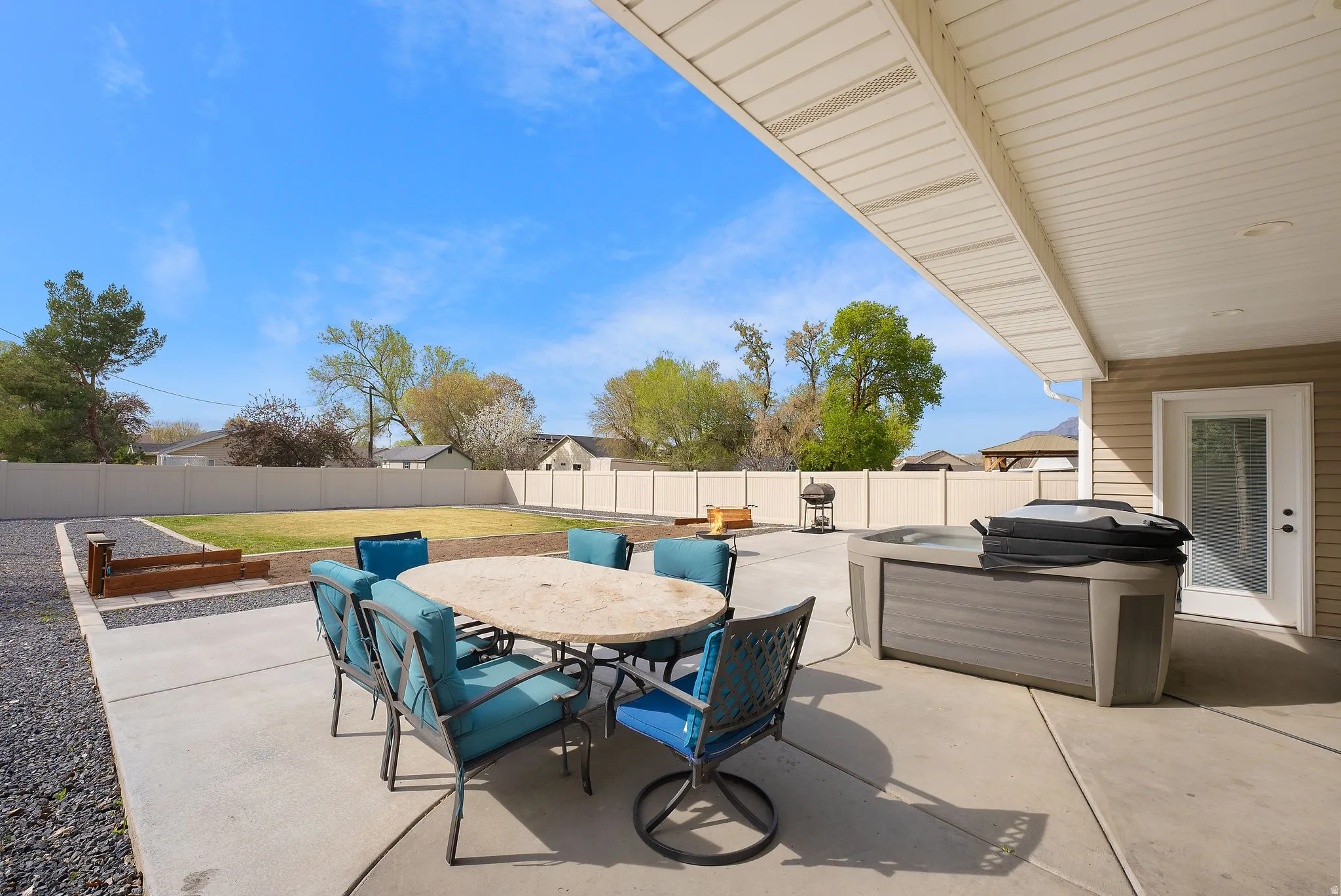 Fenced backyard featuring a patio and outdoor dining area