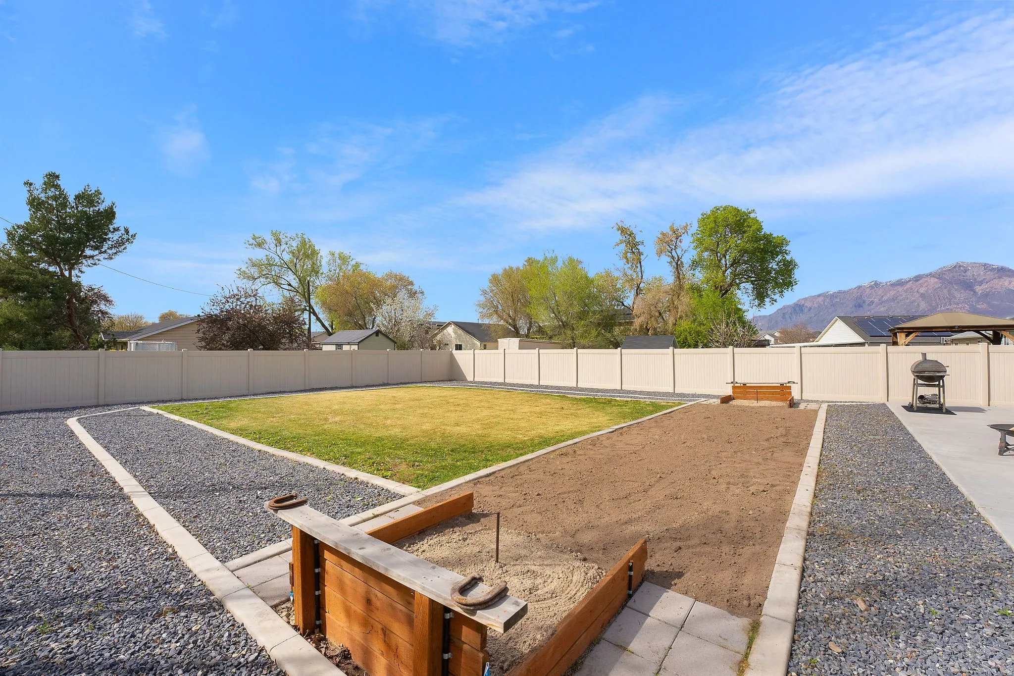 Fenced backyard with a patio area and a mountain view