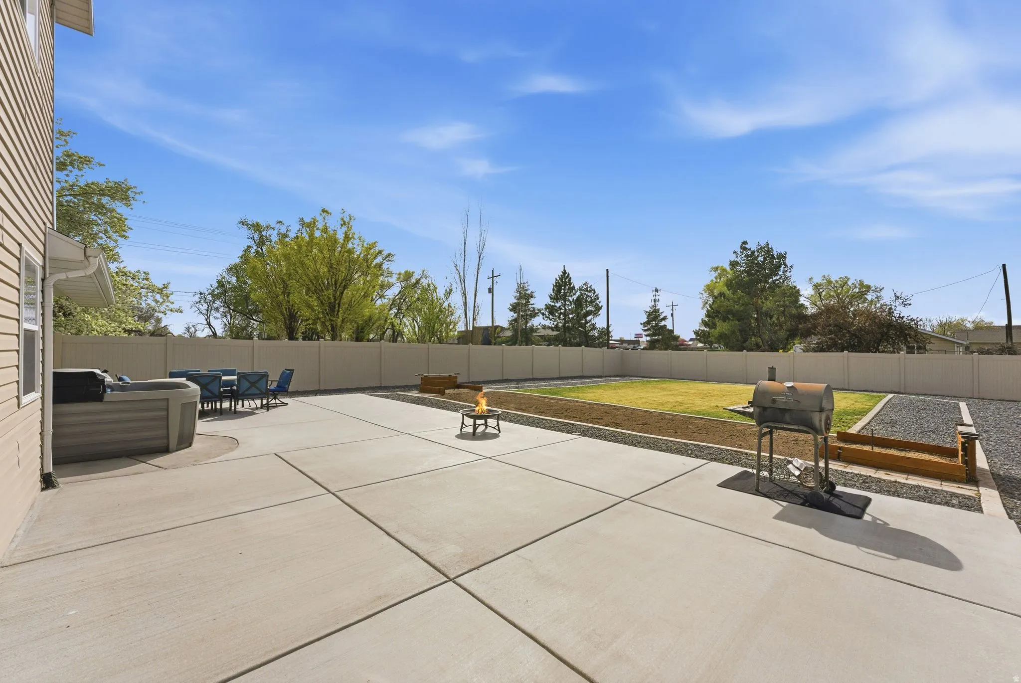 Fenced backyard with a patio area and outdoor dining area
