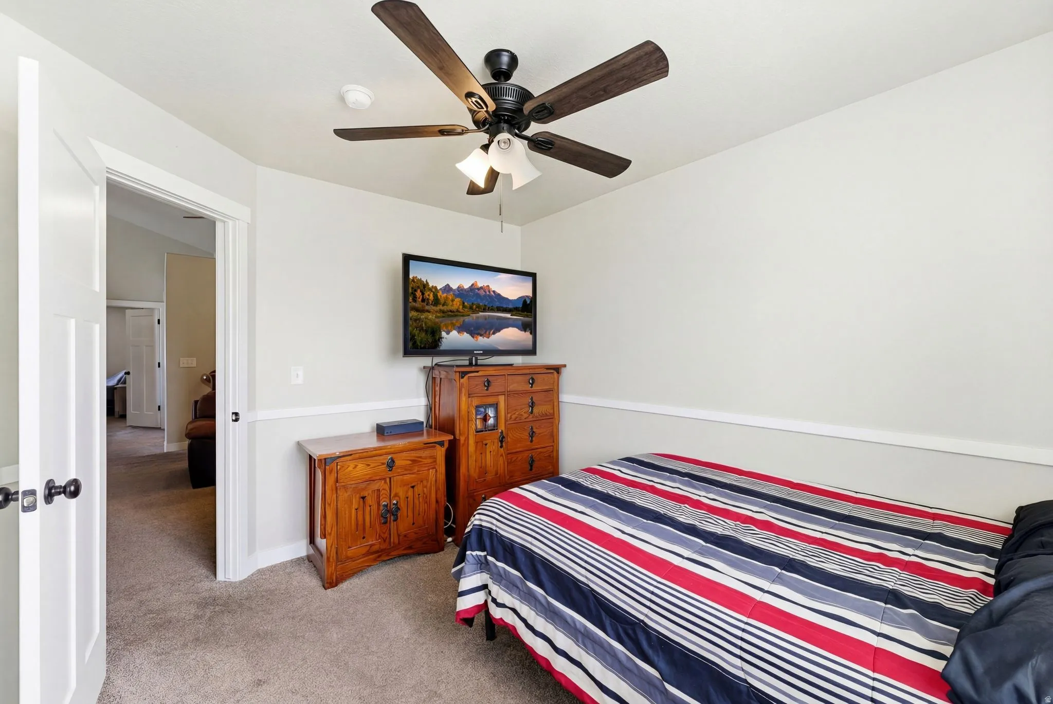 Bedroom featuring light colored carpet and ceiling fan