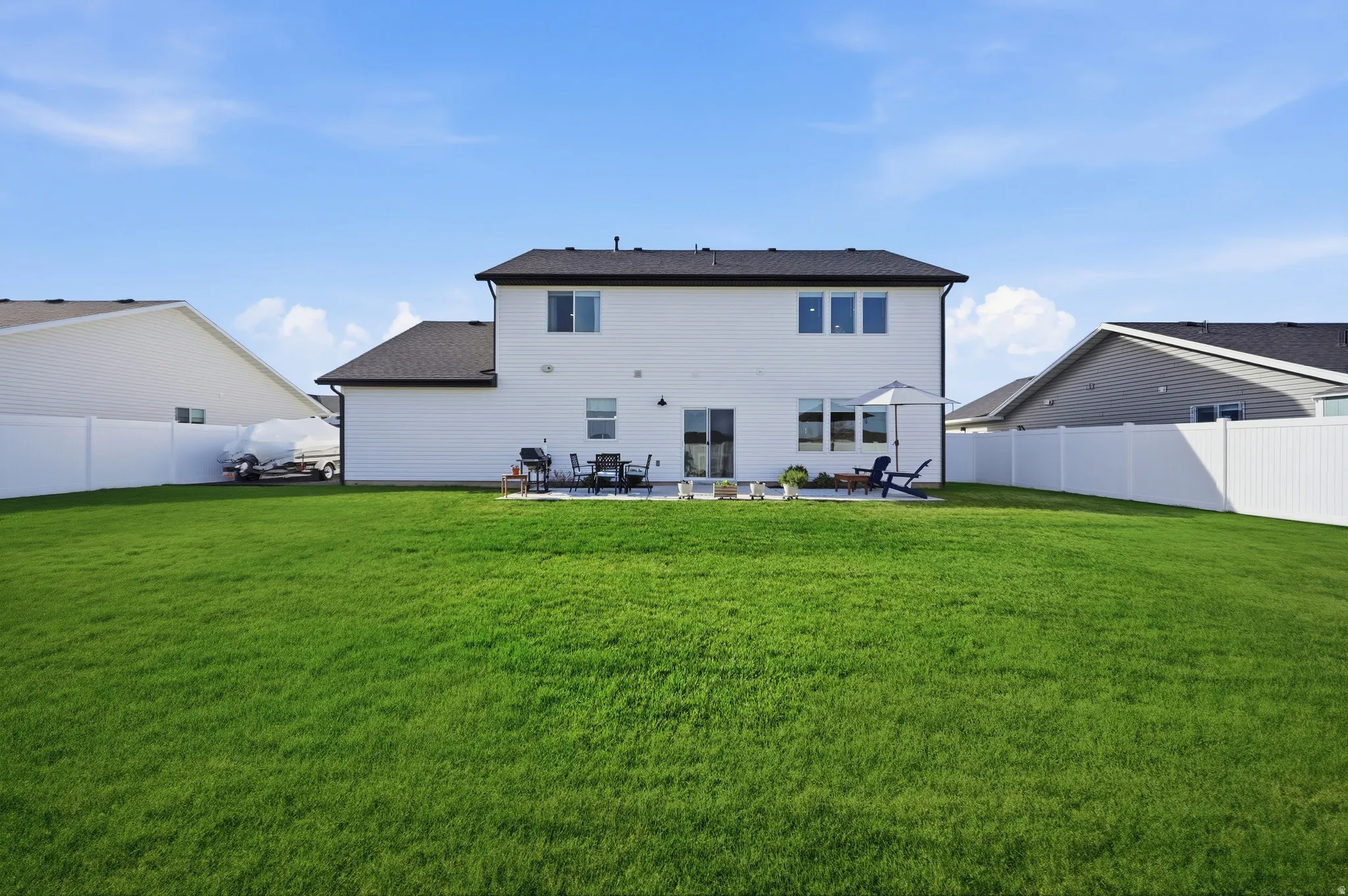 Rear view of property featuring a patio area and a fenced backyard
