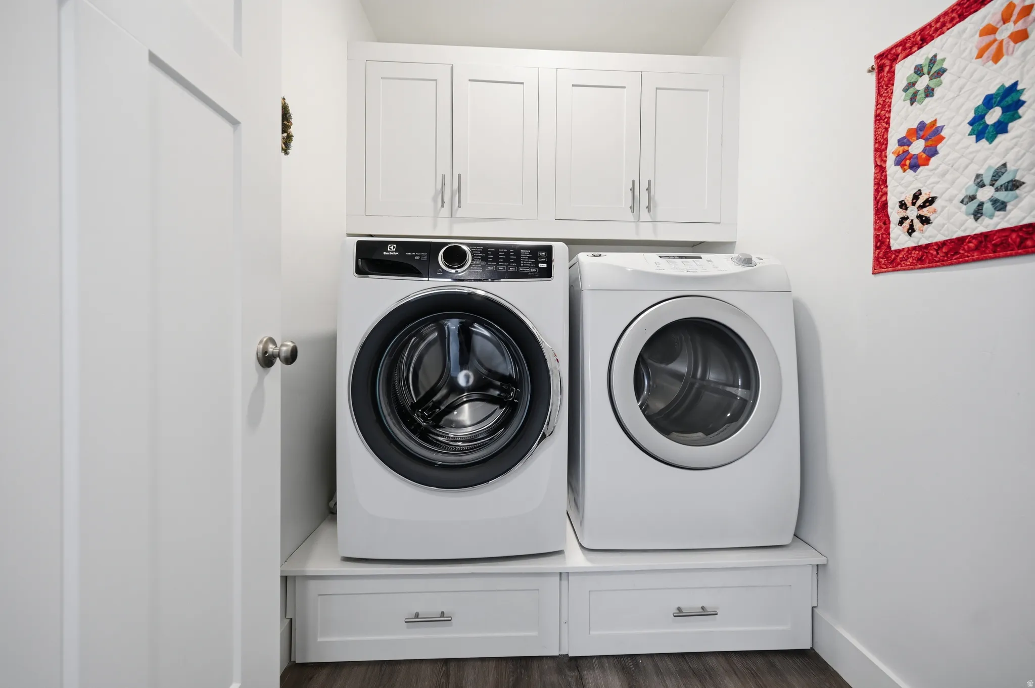 Laundry room featuring separate washer and dryer, cabinet space