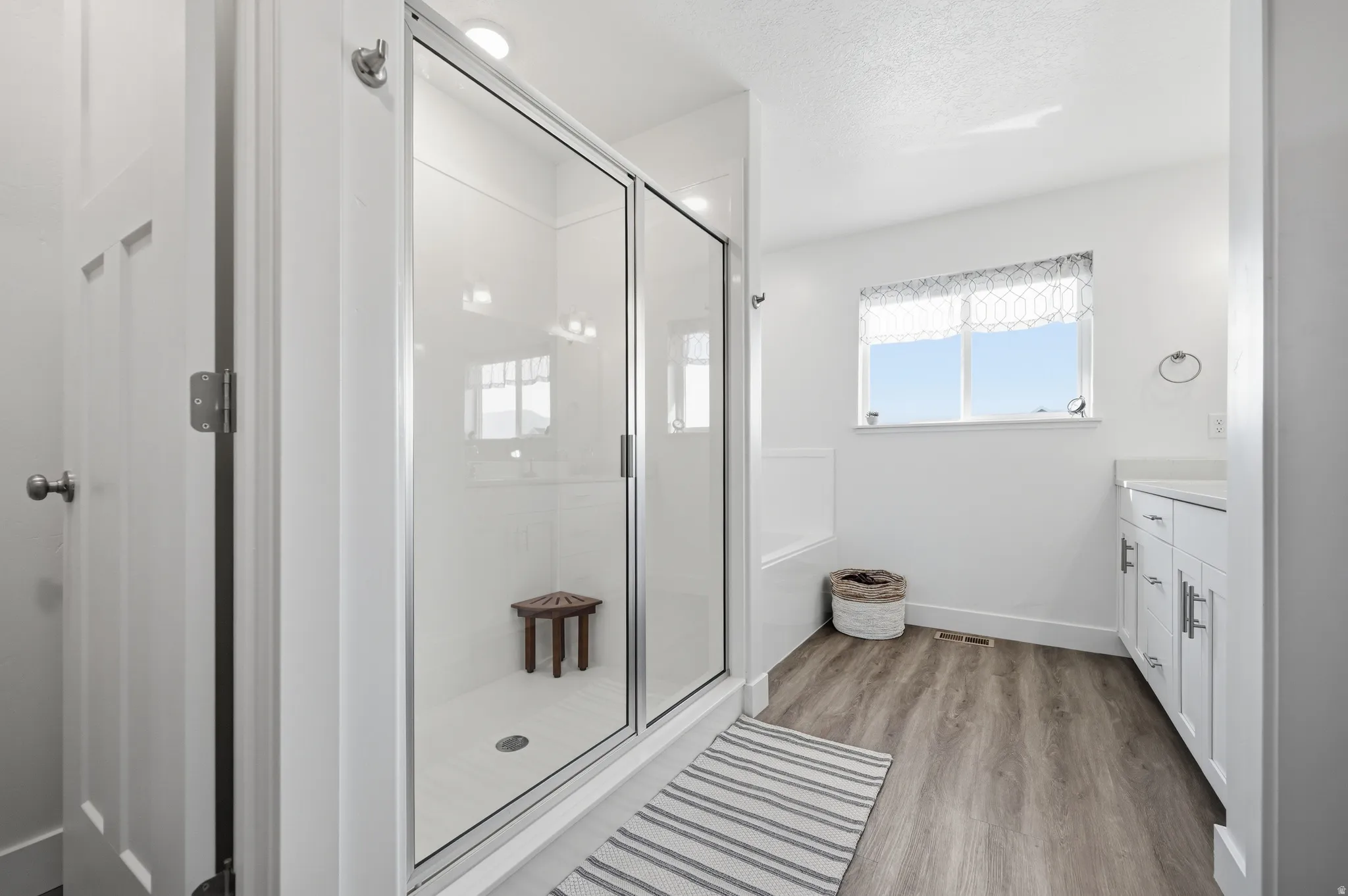 Bathroom with vanity, soaker tub and separate shower