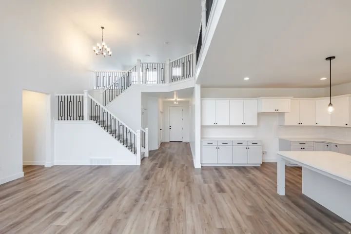 Vaulted ceilings enhance this open-concept interior featuring wood-finish flooring