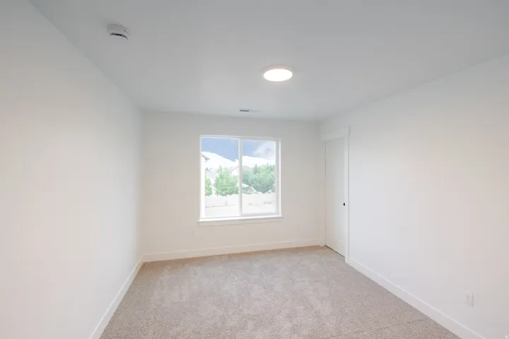 Room featuring neutral carpeting, white walls, and a recessed ceiling light