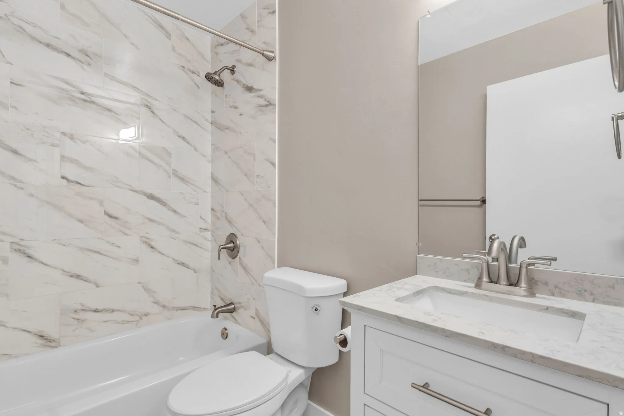 Bathroom featuring new vanity and tub / shower combination