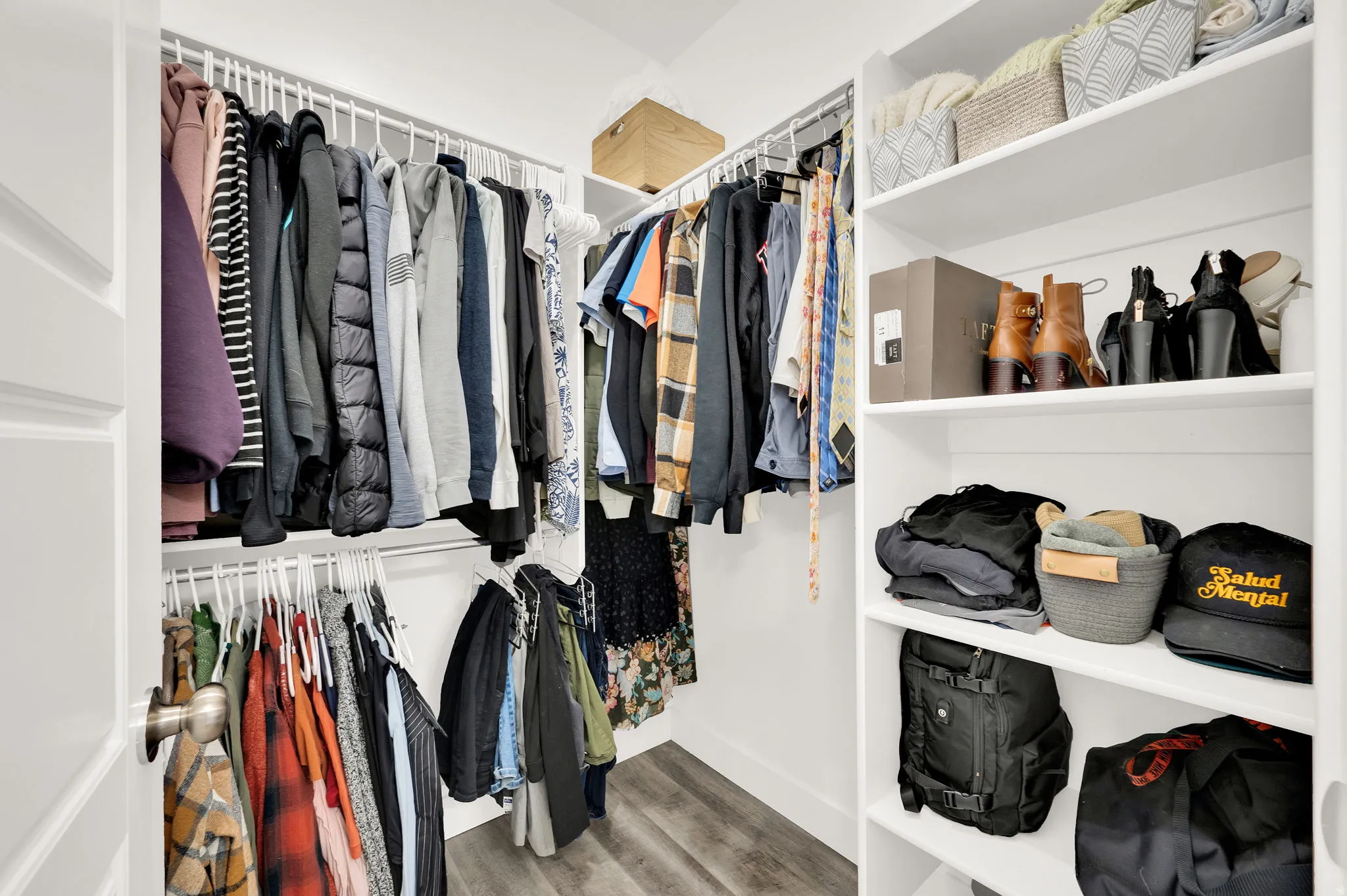 Walk in closet with light wood-style floors