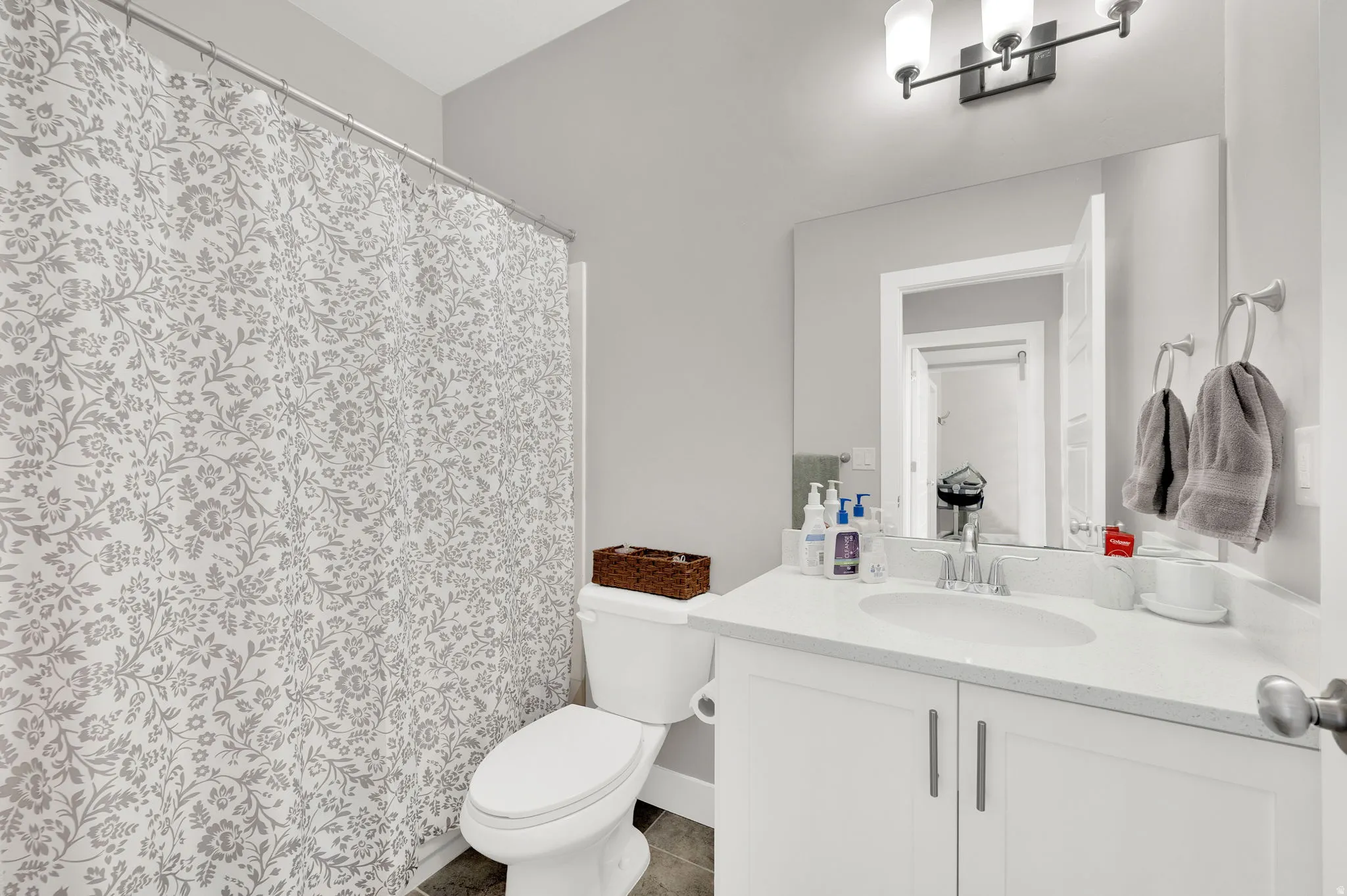 Bathroom with vanity and a shower with shower curtain