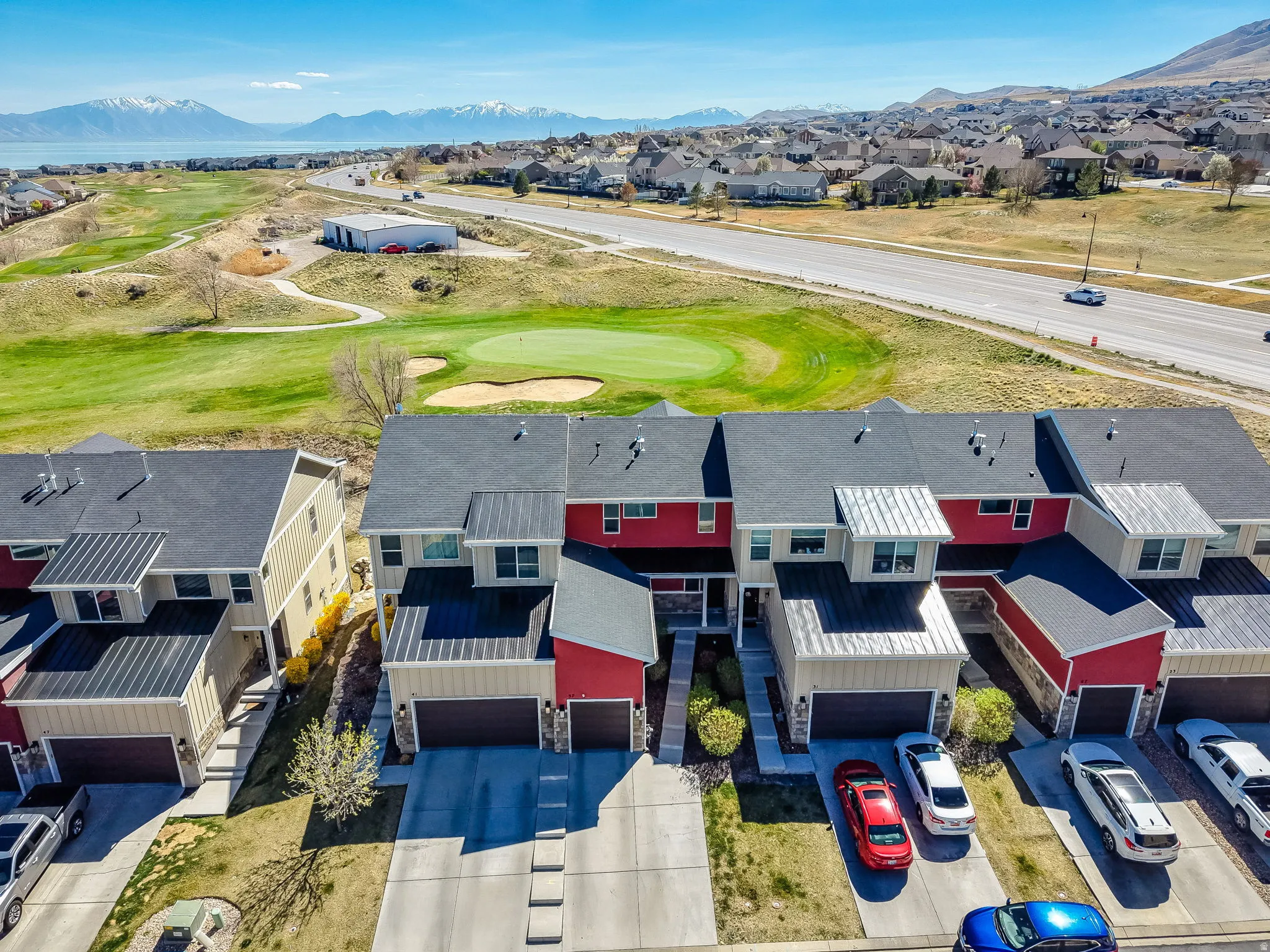 Aerial perspective of suburban area with a local golf course and mountains