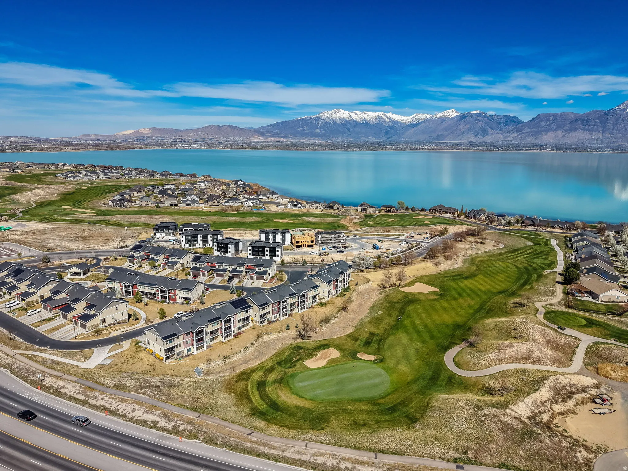Aerial view of a golf club and a water and mountain view