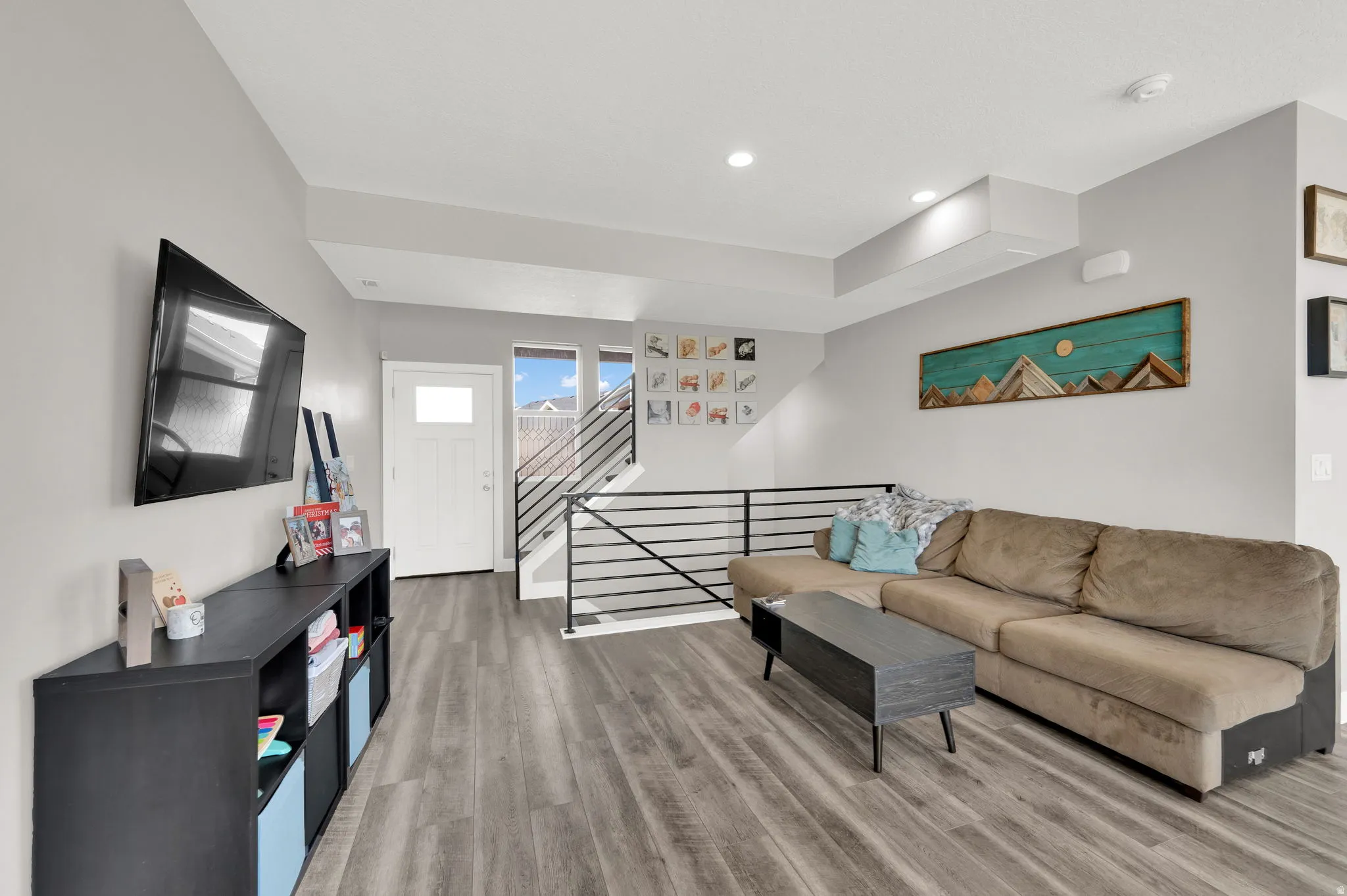 Living area with light wood-type flooring and stairs
