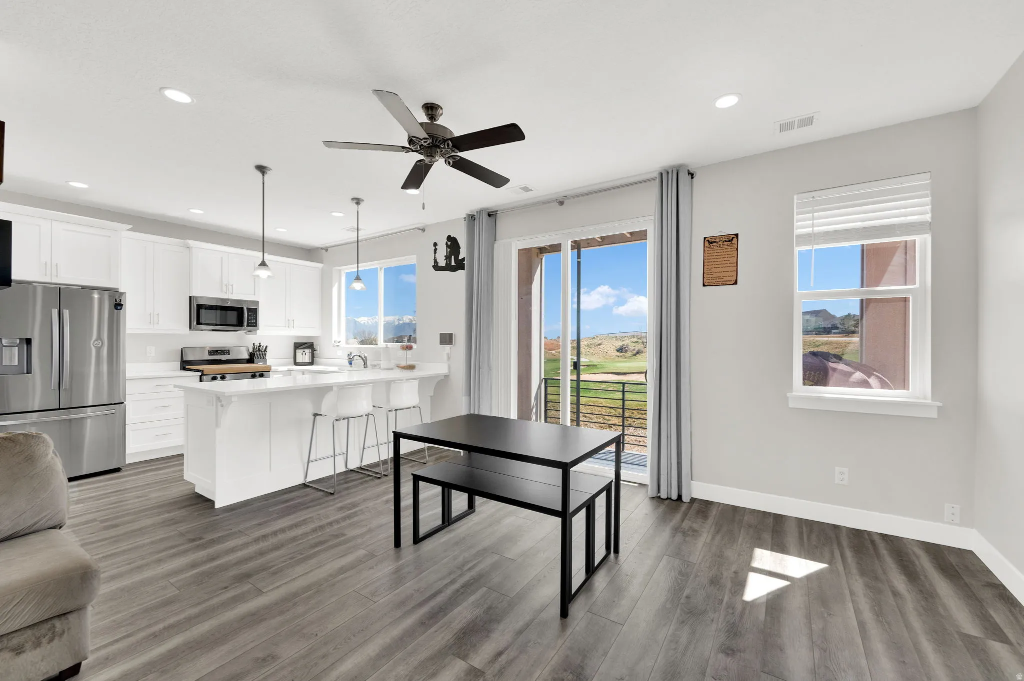 Dining area with ceiling fan, light wood finished floors, and recessed lighting