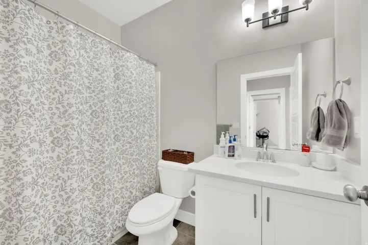Bathroom with vanity and a shower with shower curtain