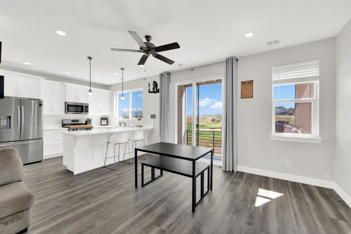 Dining area with ceiling fan, light wood finished floors, and recessed lighting