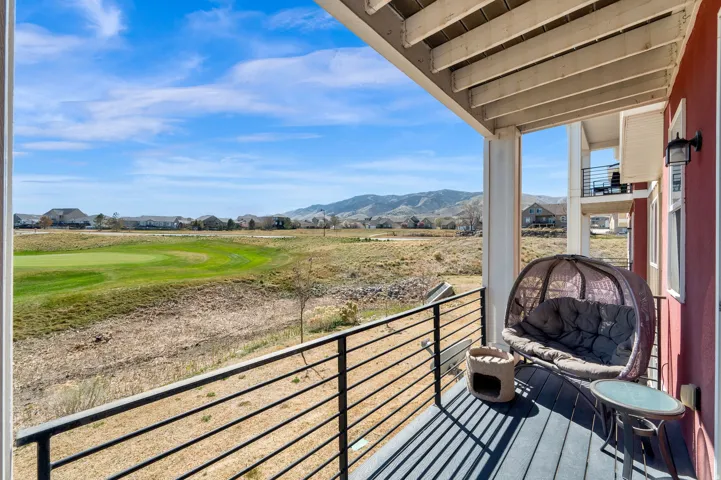 Balcony featuring a mountain view and view of golf course