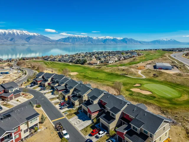 Aerial view of residential area with a golf club and a water and mountain view